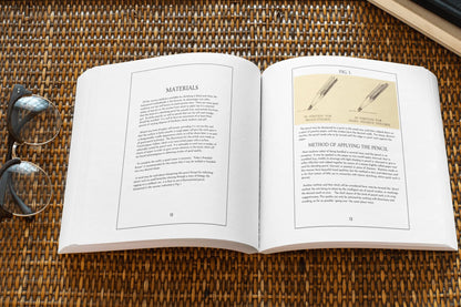 Open paperback book titled "Pencil Sketching Revised" by Solar Spectrum Press showing detailed interior pages with sketching techniques.